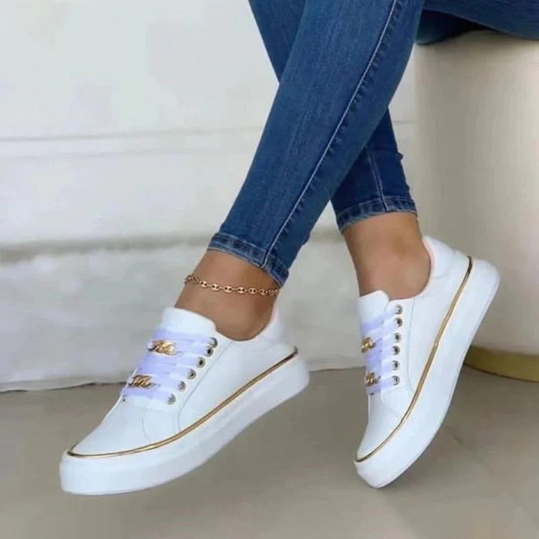 Białe damskie buty sportowe Nina, nowoczesny design, elegancja i komfort, idealne do miejskiego i aktywnego stylu.