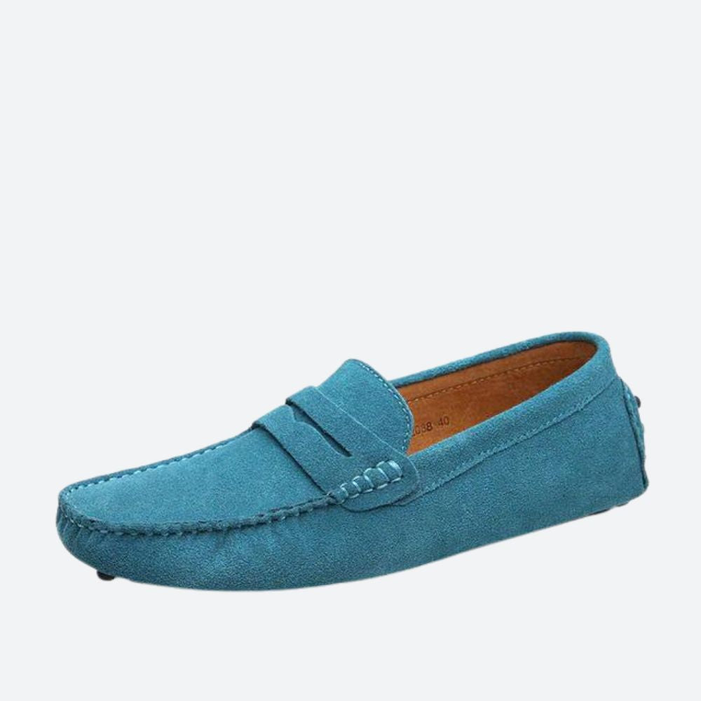Błękitne eleganckie buty skórzane męskie, na białej powierzchni.