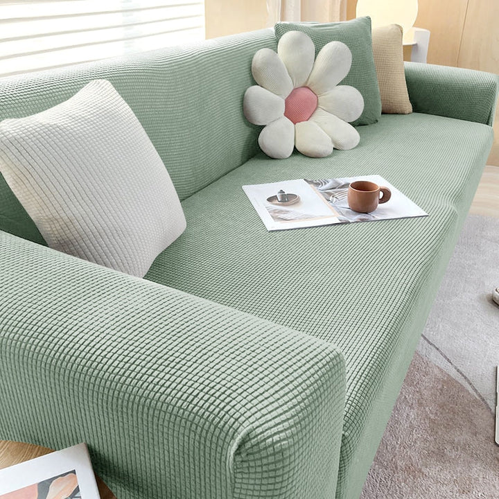 Housse de canapé extensible beige avec motif élégant et design antidérapant, disponible en plusieurs tailles pour salons mode