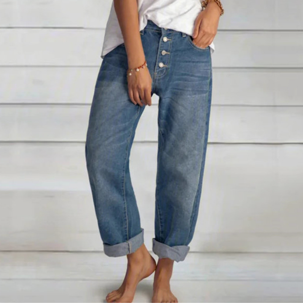 Damskie jeansy vintage z wysokim stanem i prostymi nogawkami, w kolorze niebieskiego denimu, z detalami w postaci wielu guzików z przodu.