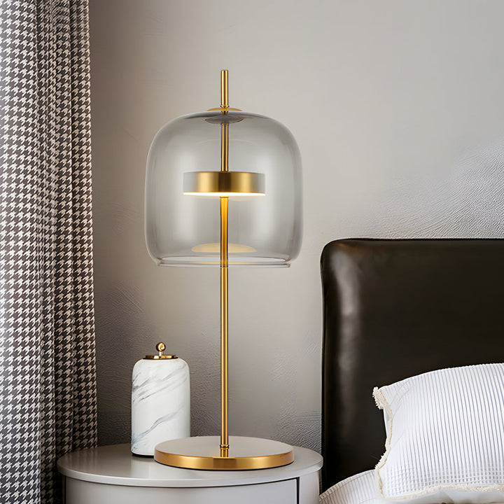 Lampa stołowa z przydymionego szkła, nowoczesny design, miękkie światło, idealna do wystroju wnętrz, ciepła atmosfera.