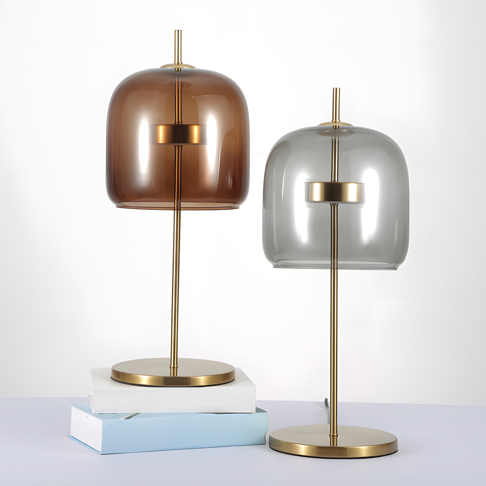Lampa stołowa z przydymionego szkła, nowoczesny design, miękkie światło, idealna do wystroju wnętrz, ciepła atmosfera.
