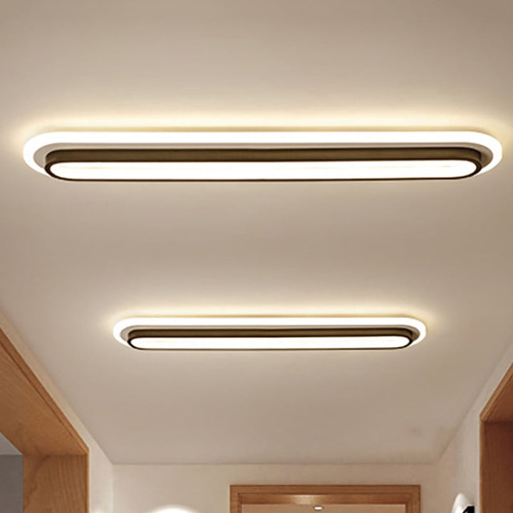 Nowoczesna owalna lampa sufitowa LED w czerni i bieli, elegancki design, akrylowy dyfuzor, współczesna elegancja do wnętrz.