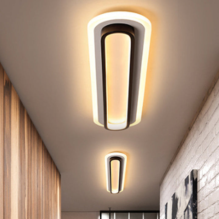 Nowoczesna owalna lampa sufitowa LED w czerni i bieli, elegancki design, akrylowy dyfuzor, współczesna elegancja do wnętrz.