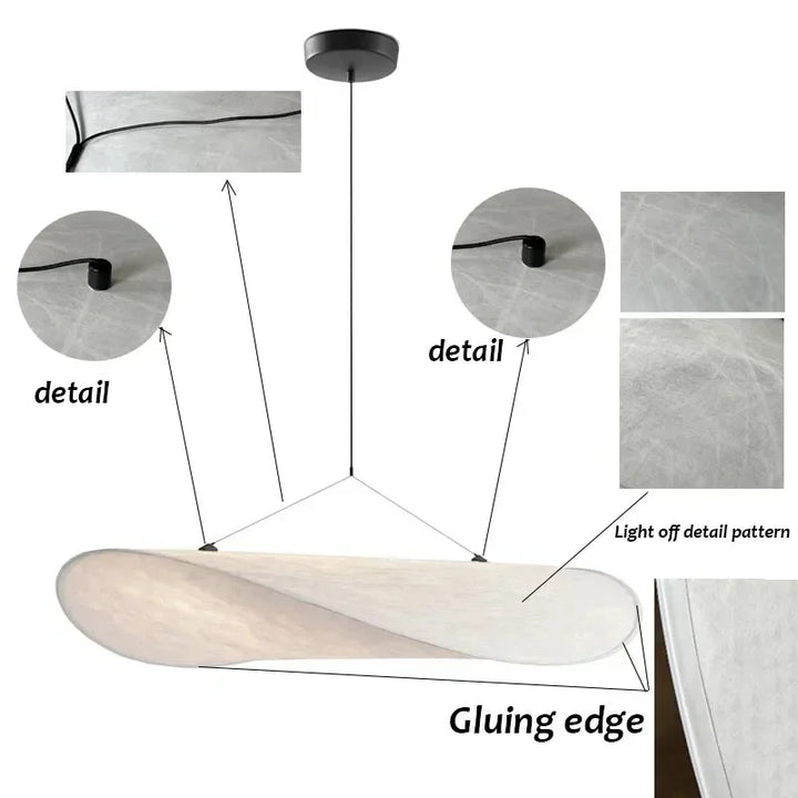 Designerski jedwabny abażur wiszący, o płynnych i eleganckich kształtach, tworzący miękkie światło dla szykownego i kojącego wnętrza.