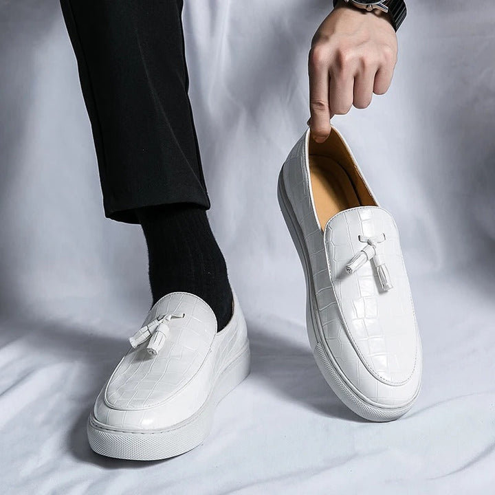 Brązowe męskie loafersy skórzane, eleganckie i wygodne, na białym tle.
