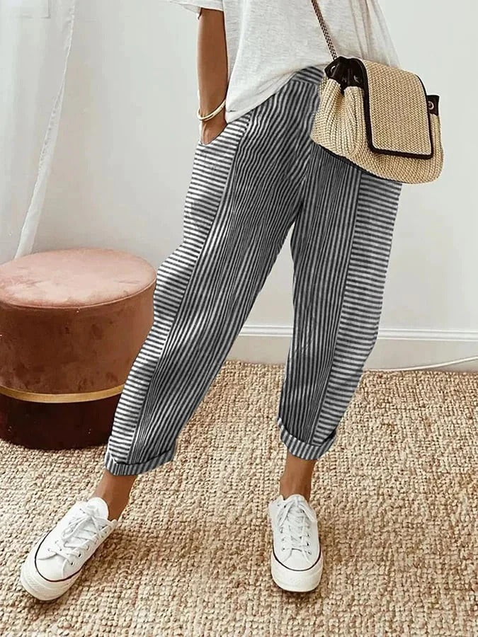 Damskie niebieskie spodnie w paski, bawełniane, wysoki stan, komfortowe i eleganckie, z praktycznymi kieszeniami, nowoczesny i lekki styl.