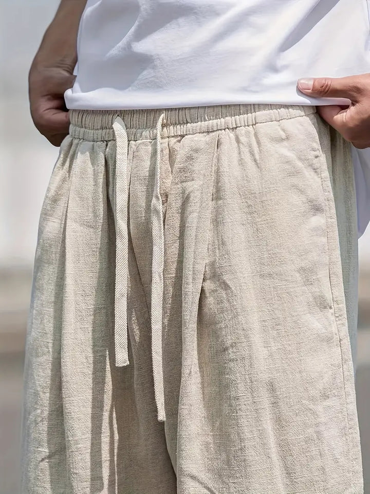 Męskie lniane spodnie typu wide leg, lekkie, oddychające, nowoczesny design zapewniający letni komfort, elegancki styl casualowy