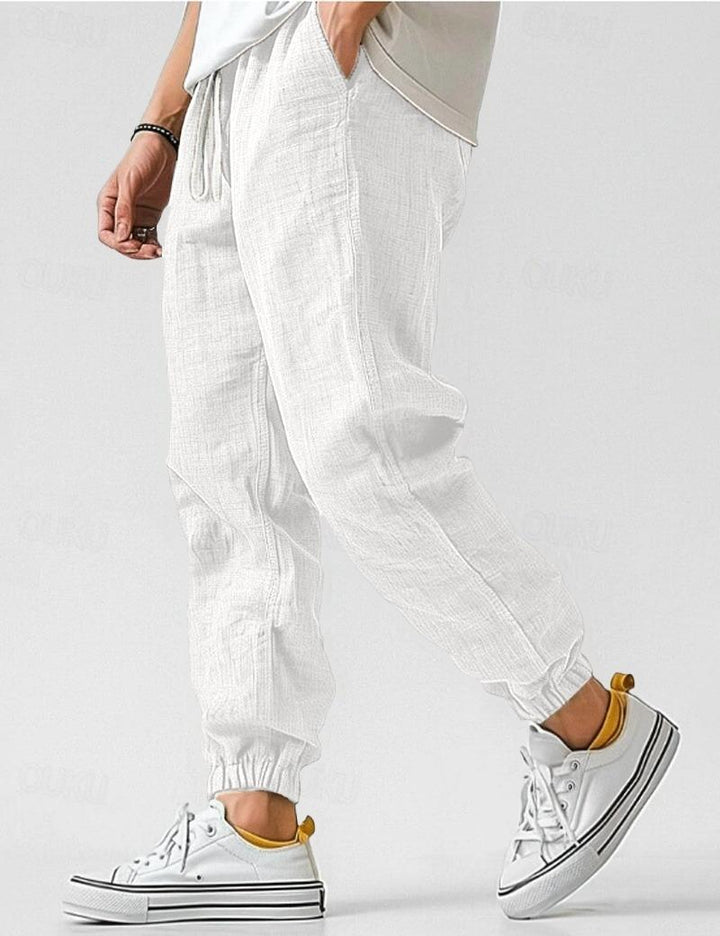 Męskie spodnie lniane w kolorze khaki, lekkie i oddychające, w stylu casual na lato, zapewniające komfort i elegancję.