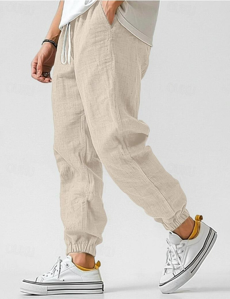 Męskie jasnozielone spodnie lniane, lekkie i oddychające, w stylu casual na lato, zapewniające komfort i elegancję.