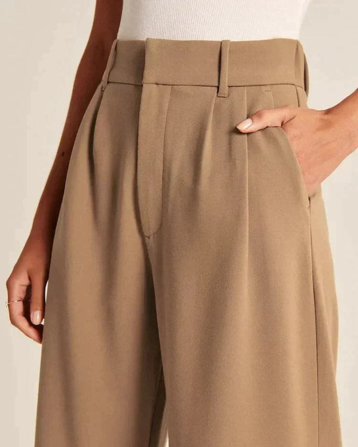 Szerokie spodnie damskie w kolorze beżowym, z wysokim stanem, eleganckie i wygodne, optycznie wydłużające nogi, idealne na każdą okazję.