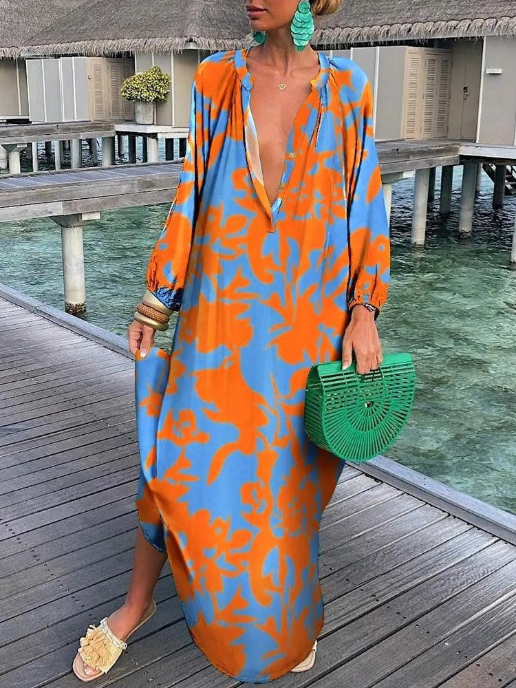Niebieska sukienka boho Rosalia z kwiatowym wzorem, zwiewna i elegancka, idealna na lato, szykowna i swobodna.