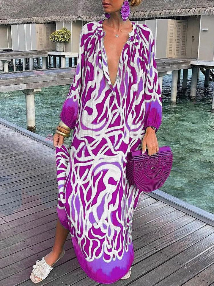 Niebieska sukienka boho Rosalia z kwiatowym wzorem, zwiewna i elegancka, idealna na lato, szykowna i swobodna.