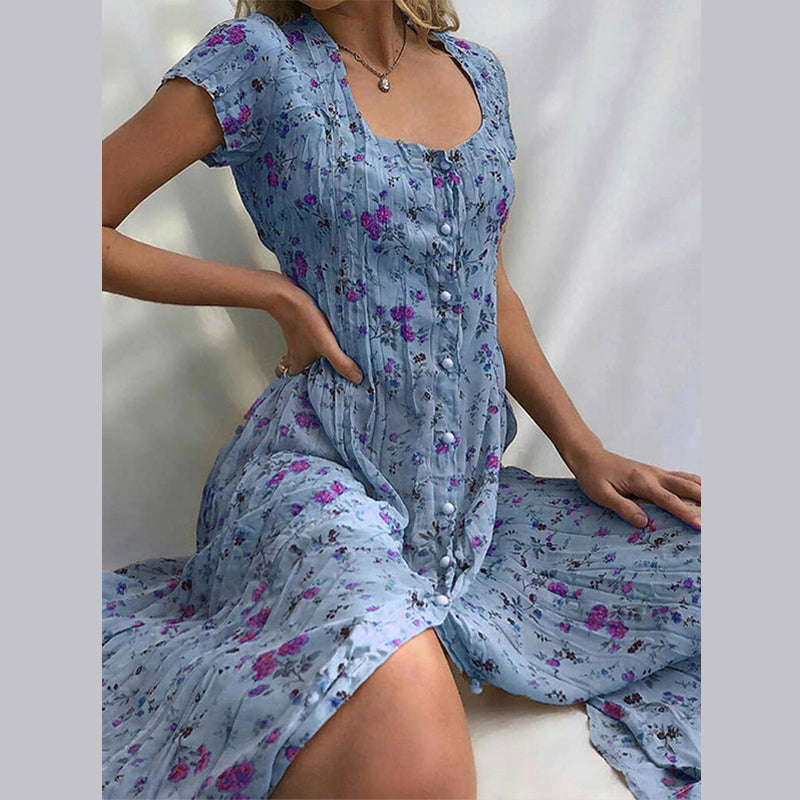 Elegancka i zwiewna letnia kwiecista sukienka Elvira, uroczy nadruk kwiatowy, płynny i pochlebny krój idealny na lato.