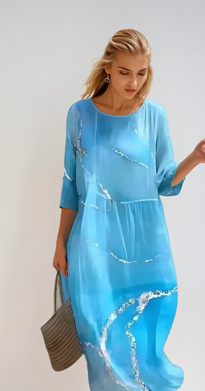 Zwiewna i elegancka letnia sukienka midi, idealna na słoneczne dni, wykonana z lekkiego materiału zapewniającego komfort i swobodny styl.