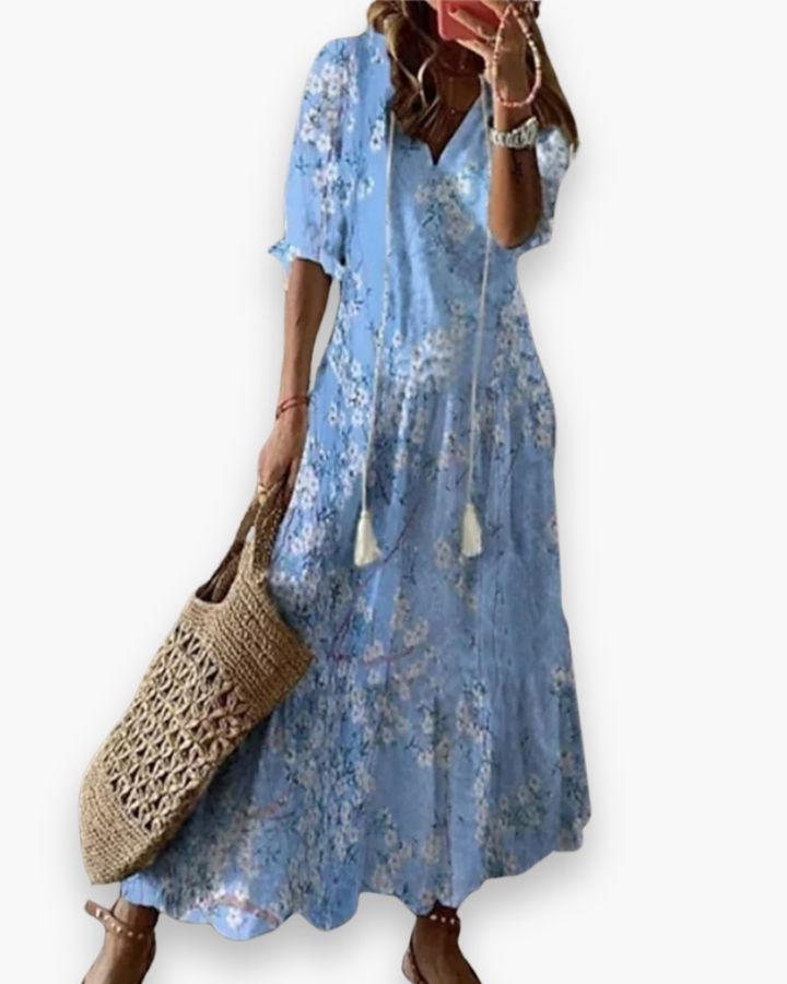 Długa damska sukienka boho, kwiatowy nadruk, elegancka i zwiewna na lato, luźny krój, romantyczny swobodny styl.