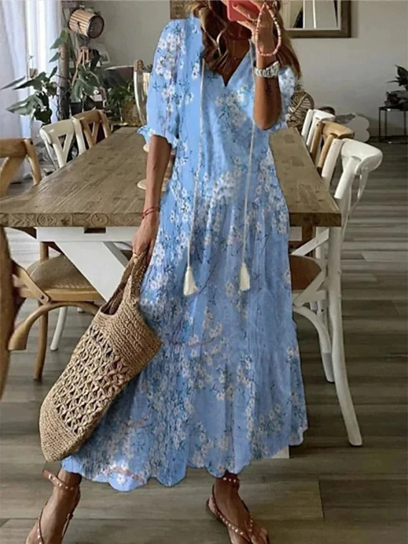 Beżowa sukienka maxi boho z etnicznymi wzorami, luźny krój, detale do wiązania, idealna na lato i elegancka.