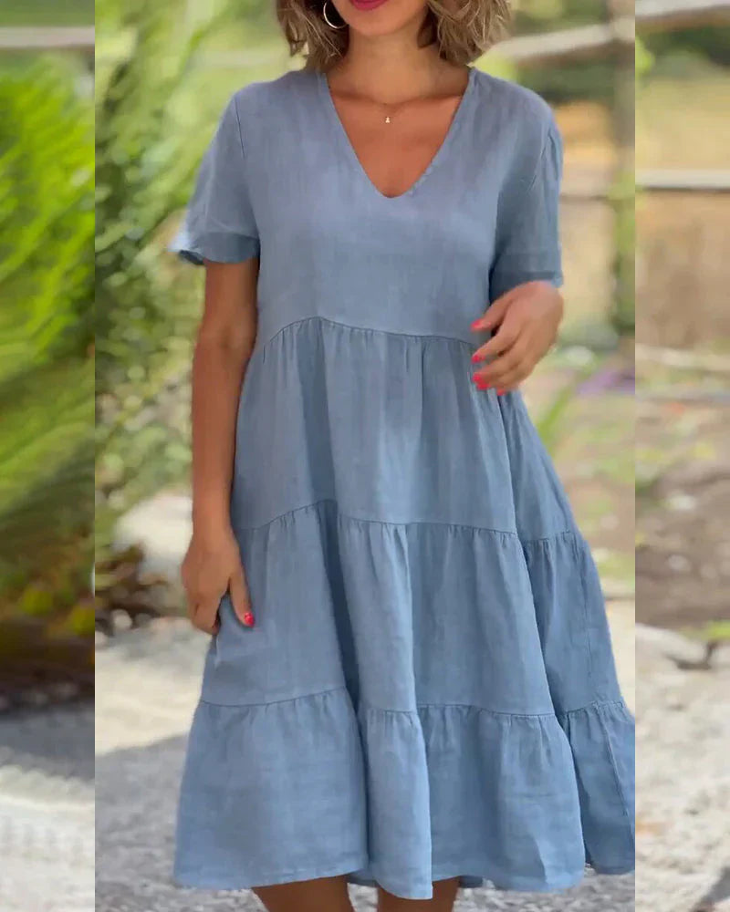 Sukienka midi z bawełny i lnu z dekoltem V, w kolorze różowym, widok z boku, podkreślająca talię.