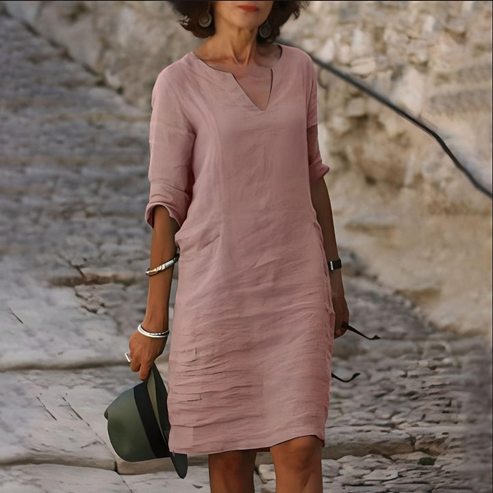 Kolorowa, elegancka i lekka sukienka midi na lato, z rozkloszowaną spódnicą i oddychającego materiału, dla eleganckiego i wygodnego letniego stylu.