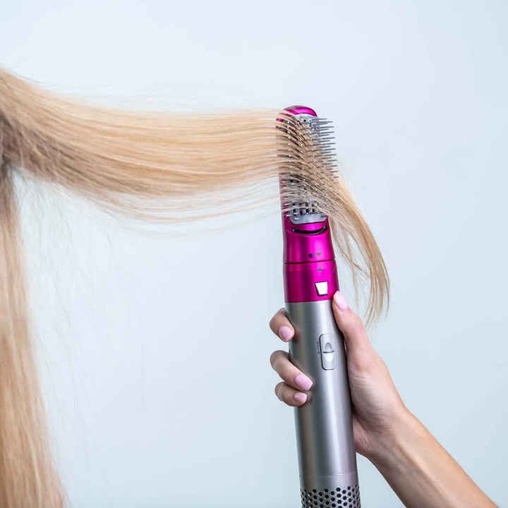 Wielofunkcyjna suszarka do włosów Styler Pro, elegancka, czarna, z wymiennymi nakładkami do różnych stylizacji, takich jak loki i prostowanie.