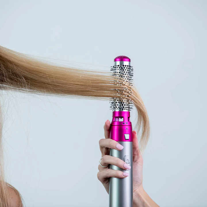 Wielofunkcyjna suszarka do włosów Styler Pro, elegancka, czarna, z wymiennymi nakładkami do różnych stylizacji, takich jak loki i prostowanie.