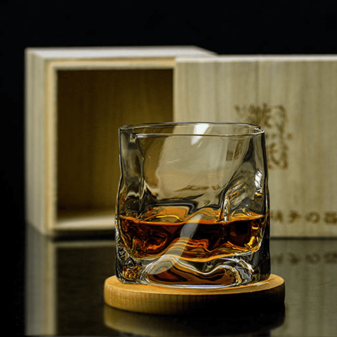 Japońska szklanka do whisky Edo Kiriko o unikalnym designie ze zgniecionej butelki, z grawerowanymi wzorami i nowoczesną estetyką.